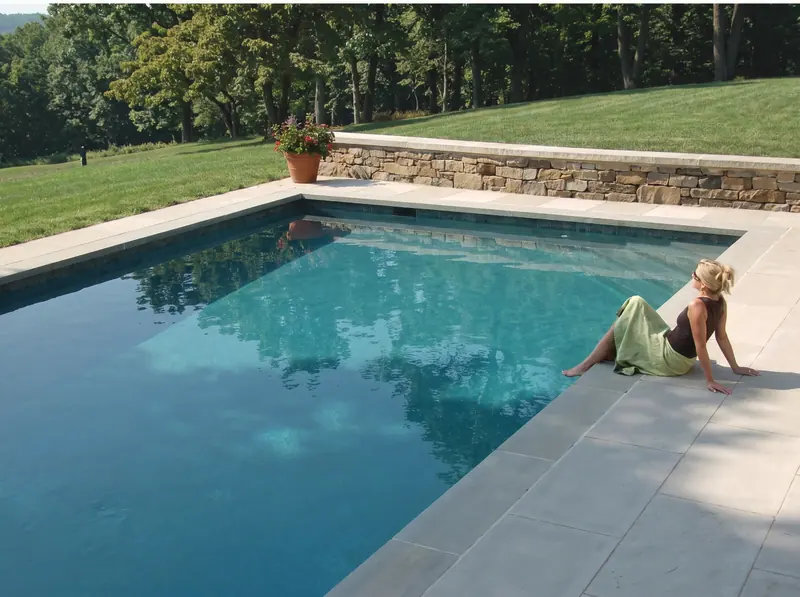 Private residence terrace in Indiana limestone: standard paving, standard pool coping and a custom wall cap